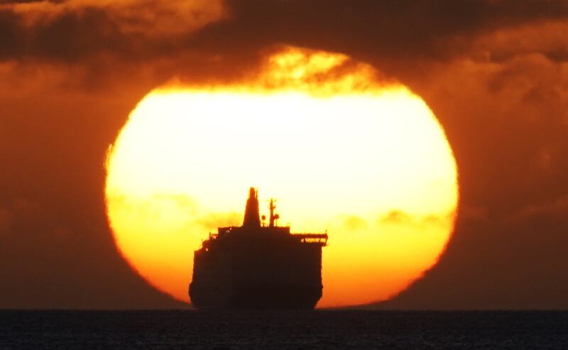The 'Princess Seaways' ferry sails along the horizon as the sun rises at Tynemouth on Monday morning. PA