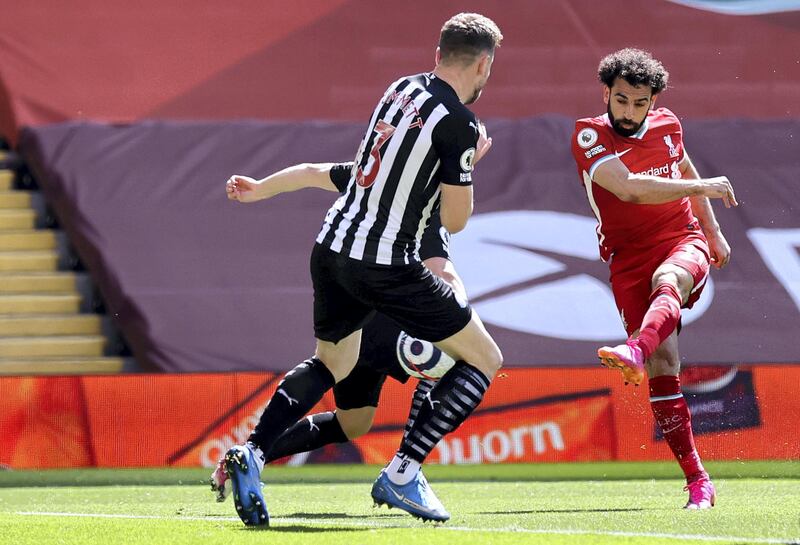 LIVERPOOL, ENGLAND - APRIL 24: Mohamed Salah of Liverpool scores their side's first goal during the Premier League match between Liverpool and Newcastle United at Anfield on April 24, 2021 in Liverpool, England. Sporting stadiums around the UK remain under strict restrictions due to the Coronavirus Pandemic as Government social distancing laws prohibit fans inside venues resulting in games being played behind closed doors.  (Photo by David Klein - Pool/Getty Images)