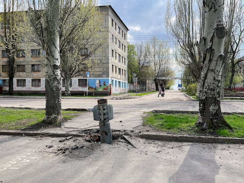 People walk past a missile stuck in the ground amid Russia's invasion of Ukraine in Rubizhne, Luhansk region, Ukraine. Reuters