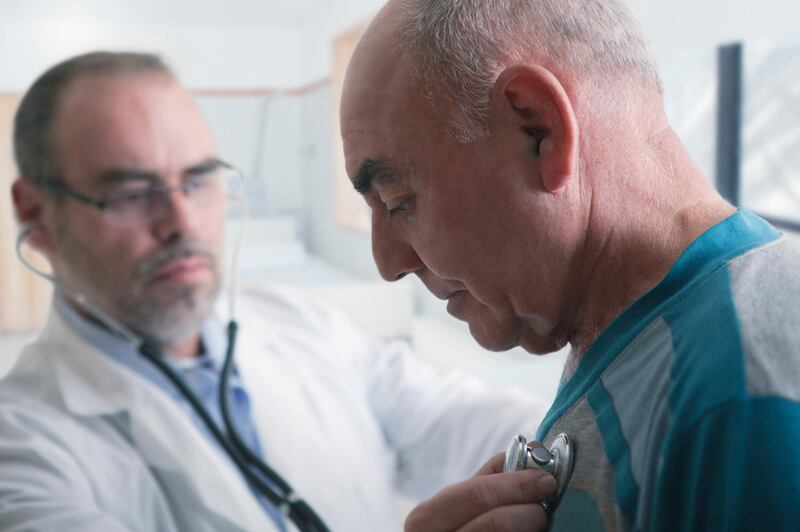 Hispanic doctor examining patient with stethoscope. Getty Images