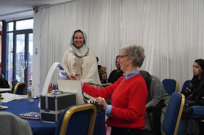 Fashion illustrator Kathy Whyte sketches an Afghan woman at a female empowerment class run by the Afghan and Central Asian Association in Feltham, West London. Victoria Pertusa / The National