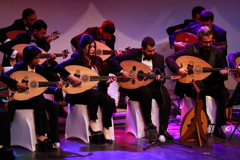 Iraqi musicians play the Oud (Ud, or oriental lute) during a concert at the al-Rasheed theatre in Iraq's capital Baghdad on December 17, 2021.  (Photo by AHMAD AL-RUBAYE  /  AFP)