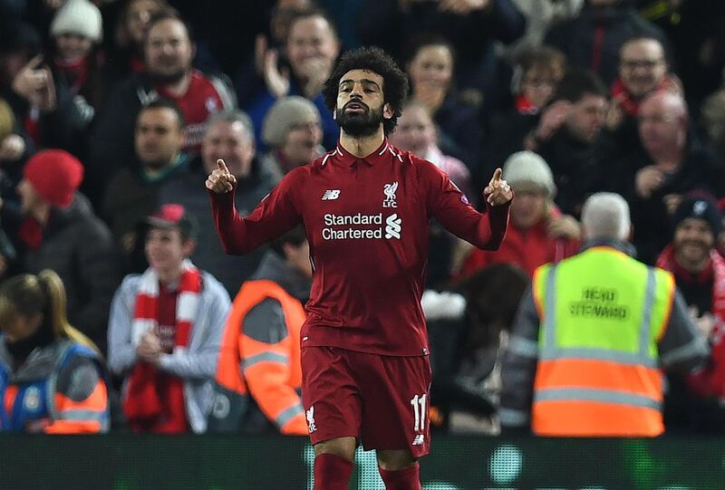 Liverpool's Egyptian midfielder Mohamed Salah celebrates scoring the opening goal during the UEFA Champions League group C football match between Liverpool and Napoli at Anfield stadium in Liverpool, north west England on December 11, 2018.  / AFP / Paul ELLIS
