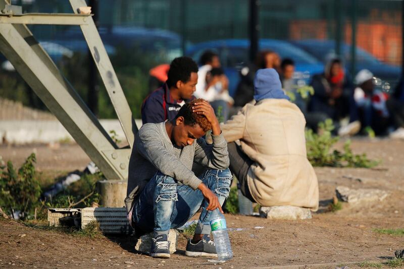 Migrants wait for a food distribution near the former "jungle" in Calais, France, August 23, 2017. REUTERS/Pascal Rossignol