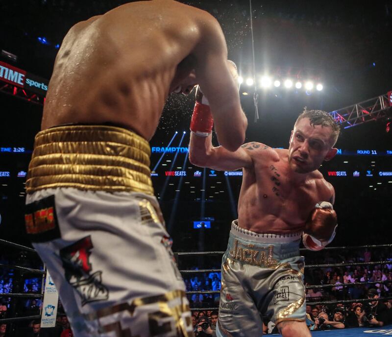 NEW YORK, NY - JULY 30: Leo Santa Cruz of Mexico (gold trunks) fights Carl Frampton of Northern Ireland (blue trunks) during their 12 round WBA Super featherweight championship bout at Barclays Center on July 30, 2016 in the Brooklyn borough in New York City.   Anthony Geathers/Getty Images/AFP (Photo by Anthony Geathers / GETTY IMAGES NORTH AMERICA / Getty Images via AFP)