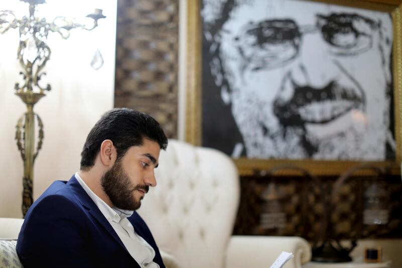 Abdullah Morsi, the youngest son of Egypt’s jailed former Islamist President Mohamed Morsi, sits in front of a framed image of his father that was printed on a flag during the 2013 Rabaah al-Adawiya sit-in, at his home in Cairo, Egypt. Abdullah is campaigning for more access to and better treatment for his father. AP