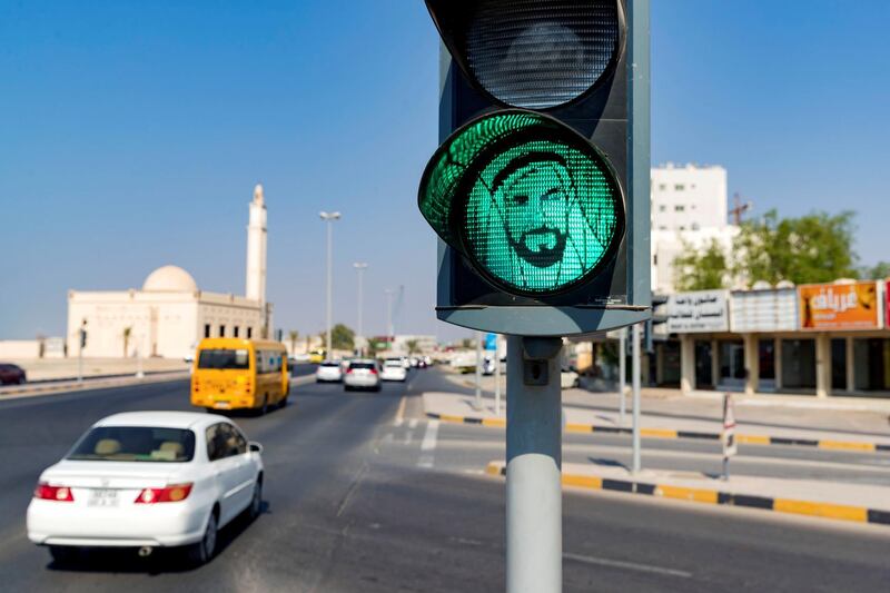 Ajman, United Arab Emirates - October 03, 2018: A traffic light goes green with the face of Sheikh Zayed in Ajman. Wednesday, October 3rd, 2018 at Al Butain, Ajman. Chris Whiteoak / The National