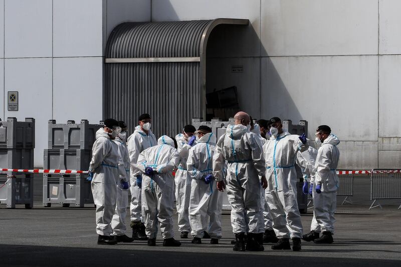 epa08497272 A handout photo made available by the German armed forces (Bundeswehr) shows soldiers taking coronavirus tests from workers at the Toennies meat factory in Rheda-Wiedenbrueck, western Germany, 19 June 2020 (issued 20 June 2020). According to media reports, more than 800 Toennies workers at the Rheda-Wiedenbrueck plant – Europe's largest slaughterhouse – have tested positive for the SARS-CoV-2 coronavirus that causes the COVID-19 disease, making it one of the largest clusters of the ongoing pandemic detected so far in the country.  EPA/KORTE / BUNDESWEHR / HANDOUT  HANDOUT EDITORIAL USE ONLY/NO SALES