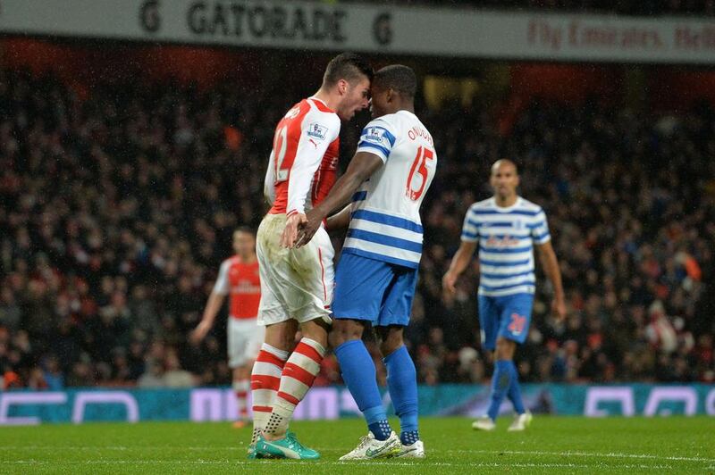 Olivier Giroud, left, was sent off for butting Queens Park Rangers defender Nedum Onuoha, but Arsenal still manage a win. Glyn Kirk / AFP