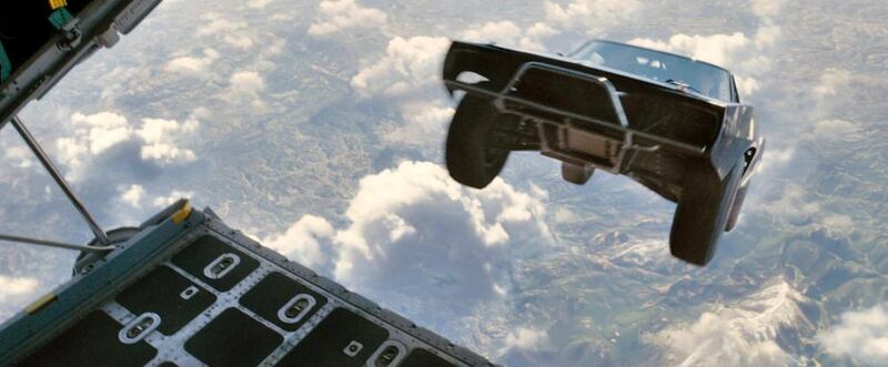A car being dropped from a plane in a scene from Furious 7. Courtesy Universal Pictures 
