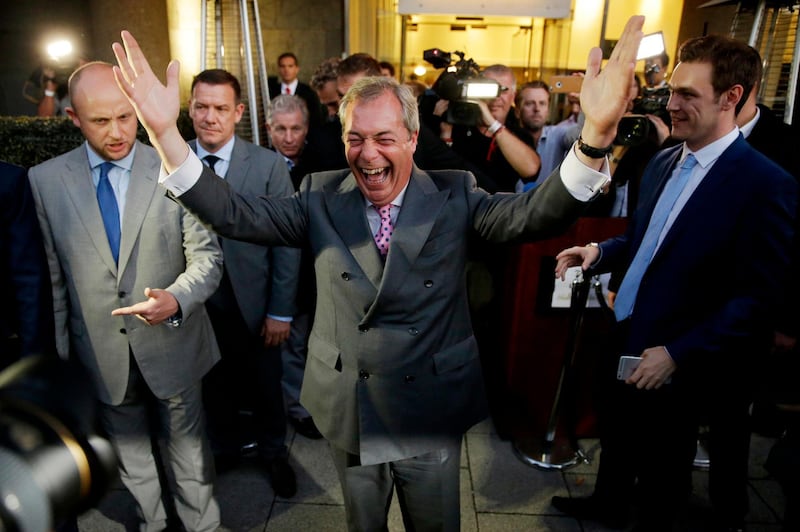 Nigel Farage, the leader of the UK Independence Party, celebrates and poses for photographers during a "Leave EU" party in London, in June 2016, after the voters chose to leave. AP Photo