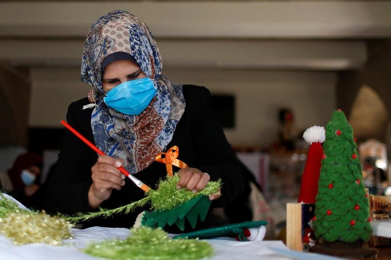 A Palestinian woman works on Christmas-themed gifts in a handicraft workshop in the northern Gaza Strip. Reuters