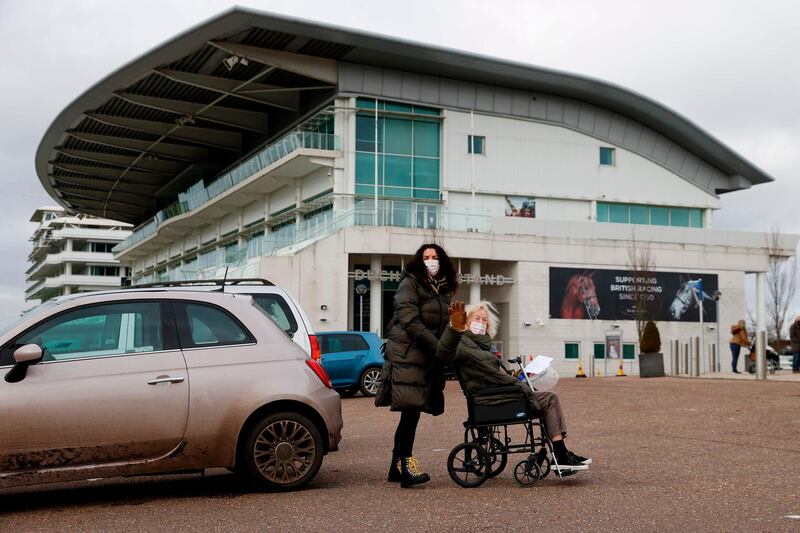 People arrive at Epsom Downs Racecourse as it opens as a Covid-19 mass vaccination centre. AFP