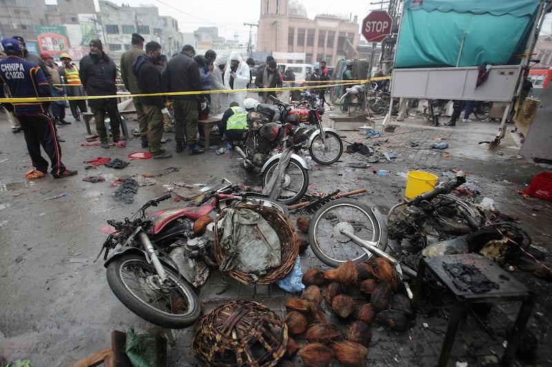 Members of crime scene and bomb disposal units gather after an explosion in a market in Lahore, Pakistan. Reuters