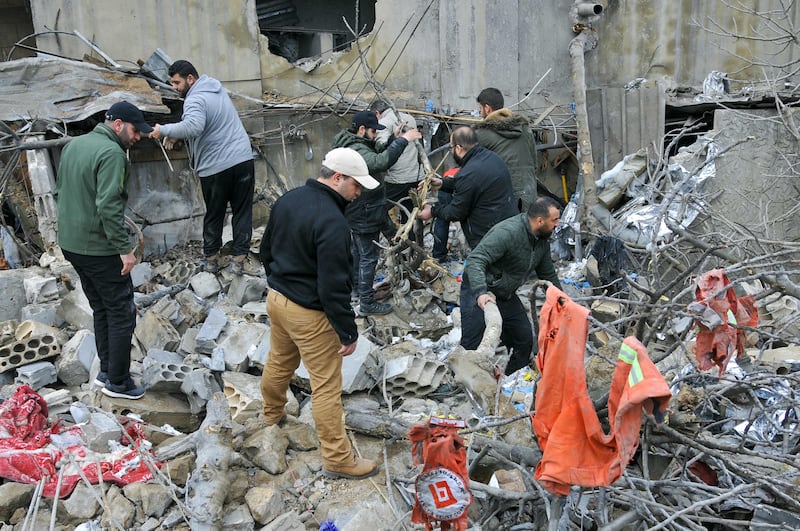 People inspect the site of an overnight Israeli air strike in Habariyeh, near the Israeli border. AFP
