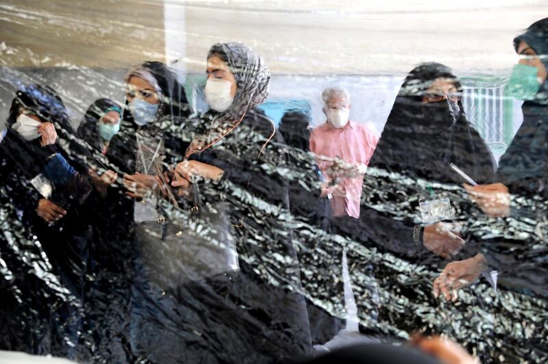 Iranians prepare for voting at a polling station in Tehran. AP Photo