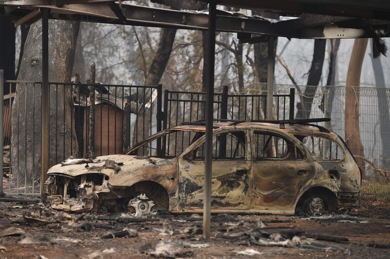 A burnt-out car is seen on property razed by bushfires in Bargo, southwest of Sydney. AFP