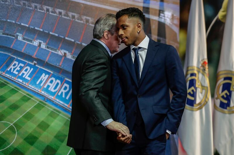 Rodrygo shakes hands with Real Madrid President Florentino Perez. AP Photo