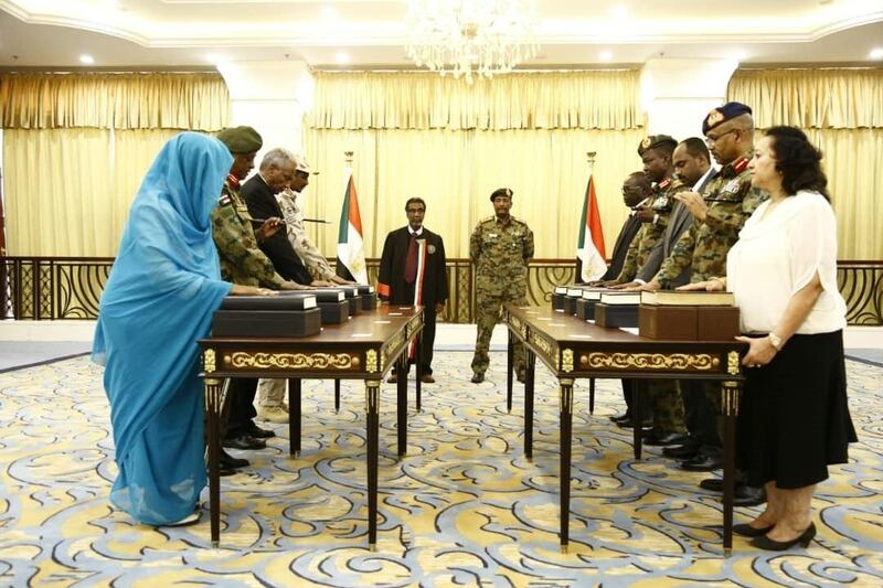 A picture released by Sudan's Presidential Palace shows General Abdel Fattah al-Burhan (C-R), the head of Sudan's ruling military council, standing during a swearing in of the new sovereign council, in Khartoum on August 21, 2019. Sudan took further steps in its transition towards civilian rule today with the swearing in of a new sovereign council, to be followed by the appointment of a prime minister. The body replaces the Transitional Military Council (TMC) that took charge after months of deadly street protests brought down longtime ruler Omar al-Bashir in April. Burhan, who already headed the TMC, was sworn in as the chairman of the new sovereign council in the morning.
 / AFP / SUDAN PRESIDENTIAL PALACE / - /  RESTRICTED TO EDITORIAL USE - MANDATORY CREDIT "AFP PHOTO / SUDAN PRESIDENTAIL PALACE" - NO MARKETING NO ADVERTISING CAMPAIGNS - DISTRIBUTED AS A SERVICE TO CLIENTS

