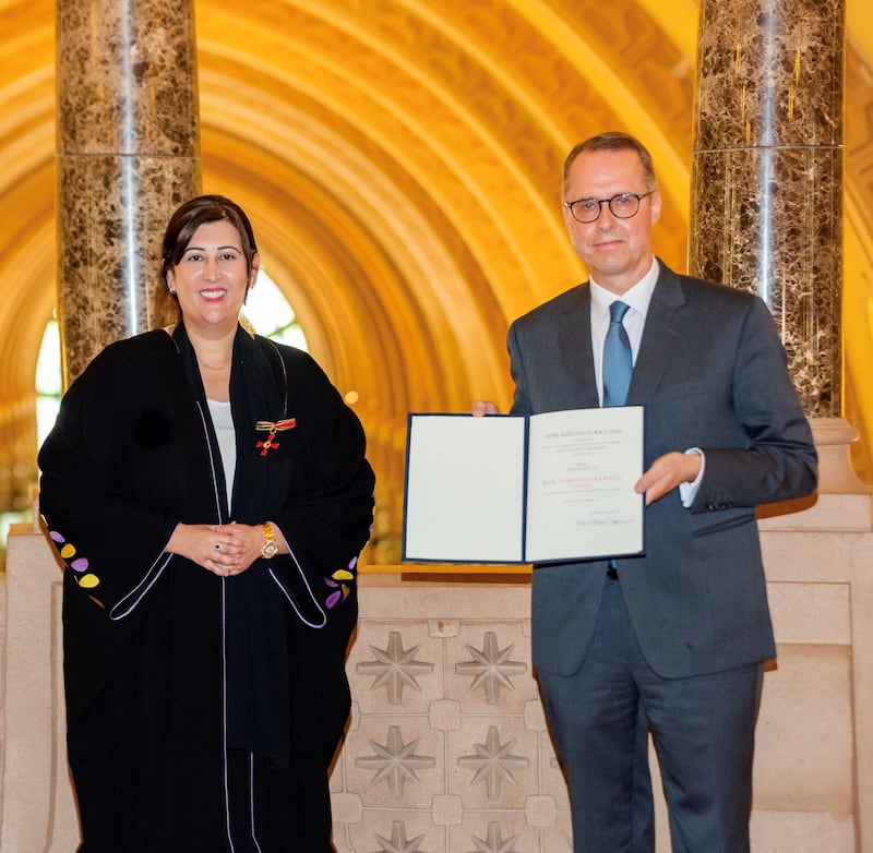Manal Ataya, director general of Sharjah Museums Authority, receives the Order of Merit from Ernst Peter Fischer, German ambassador to the UAE, at the Sharjah Museum of Islamic Civilisation. Photo; Sharjah Museums Authority