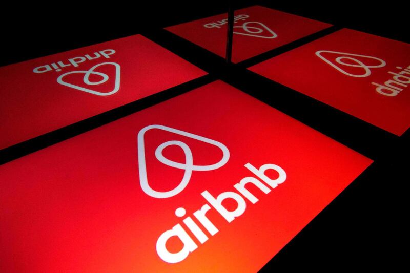 (FILES) In this file illustration photo taken on November 22, 2019 shows the logo of the online lodging service Airbnb displayed on a tablet in Paris. Home-sharing giant Airbnb, which is scheduled to go public this week, will significantly raise its IPO price, valuing the group at more than $40 billion, the Wall Street Journal reported on December 6, 2020. / AFP / Lionel BONAVENTURE
