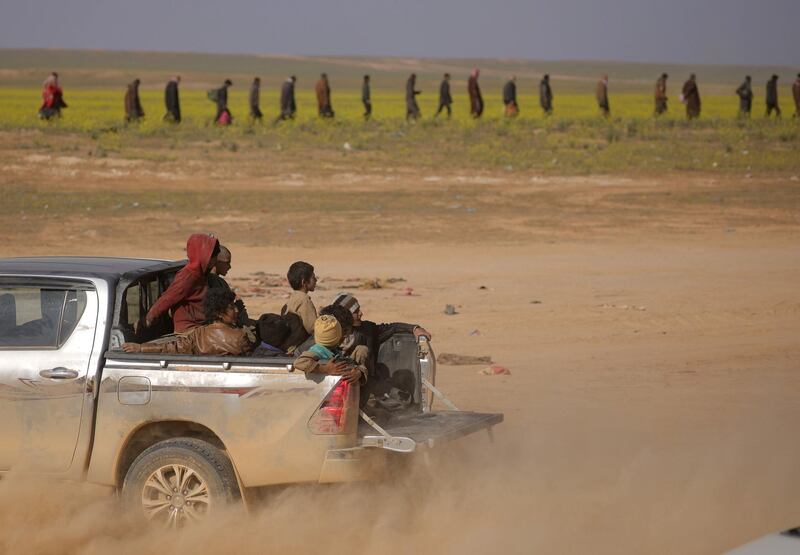 Yazidi children, who were recently freed after being captured by ISIS fighters, ride on a back of a truck near Baghouz, Der Ezzor, Syria. Reuters