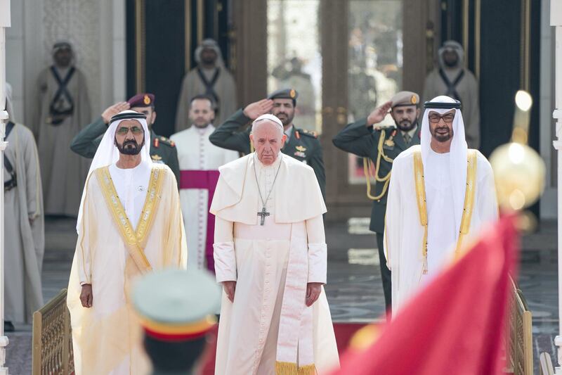 ABU DHABI, UNITED ARAB EMIRATES - February 04, 2019: Day two of the UAE papal visit - (R L) HH Sheikh Mohamed bin Zayed Al Nahyan, Crown Prince of Abu Dhabi and Deputy Supreme Commander of the UAE Armed Forces, His Holiness Pope Francis, Head of the Catholic Church and HH Sheikh Mohamed bin Rashid Al Maktoum, Vice-President, Prime Minister of the UAE, Ruler of Dubai and Minister of Defence, stand for a national anthem during a reception, at the Presidential Palace.

( Rashed Al Mansoori / Ministry of Presidential Affairs )
---