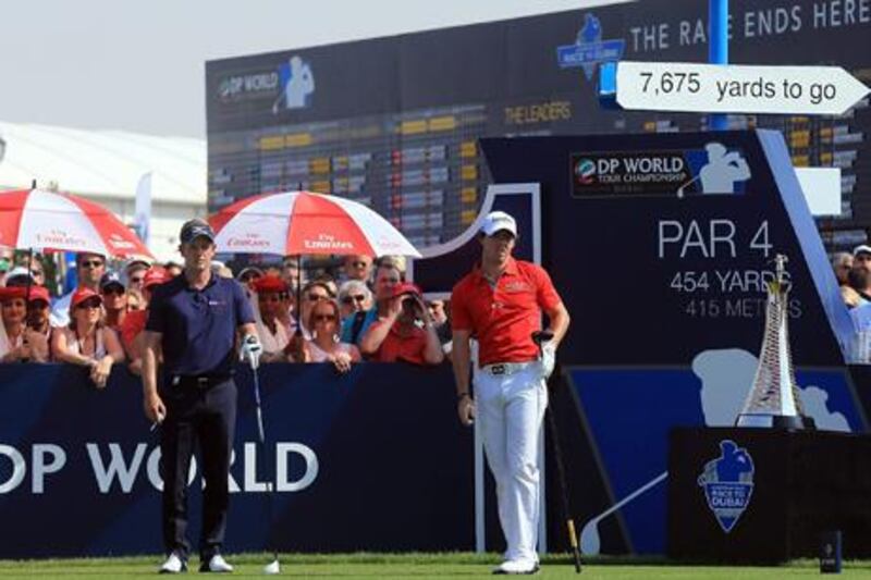 Luke Donald stands by as Rory McIlroy watches his drive off the first tee on the final day's play at the DP World Tour Championship