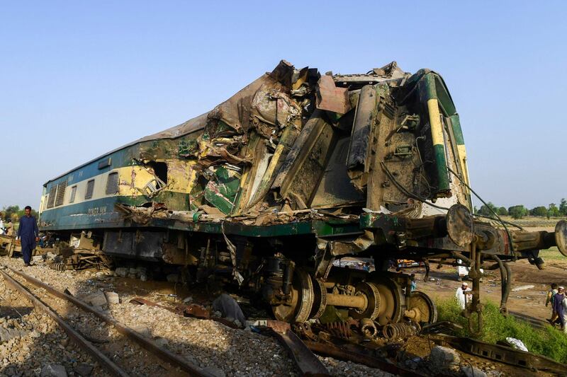 A man walks past the wreckage of a carriage. AFP