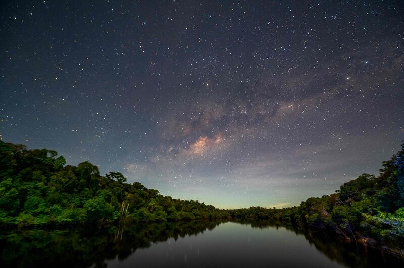 The night sky illuminates the Manicore River in the Amazon rainforest, Brazil. AFP