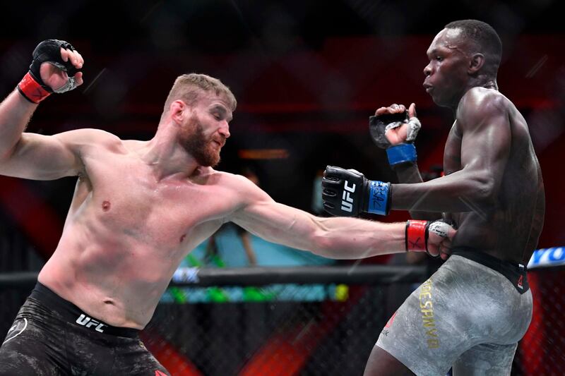 LAS VEGAS, NEVADA - MARCH 06: (L-R) Jan Blachowicz of Poland punches Israel Adesanya of Nigeria in their UFC light heavyweight championship fight during the UFC 259 event at UFC APEX on March 06, 2021 in Las Vegas, Nevada. (Photo by Chris Unger/Zuffa LLC)