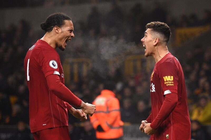 January 23, 2020, Wolves 1 Liverpool 2: Roberto Firmino (R) celebrates with Dutch defender Virgil van Dijk after scoring the second. AFP