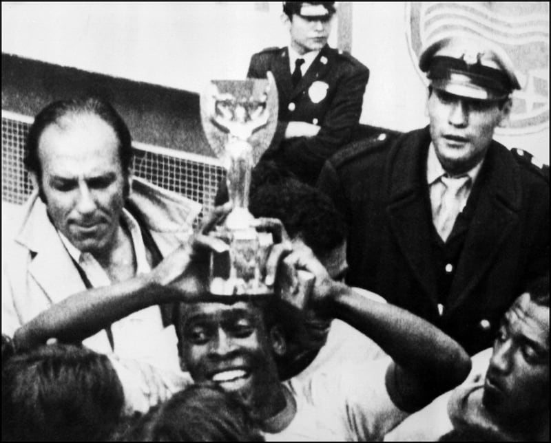 Holding aloft the trophy after Brazil beat Italy 4-1 in the World Cup final on June 21, 1970. AFP