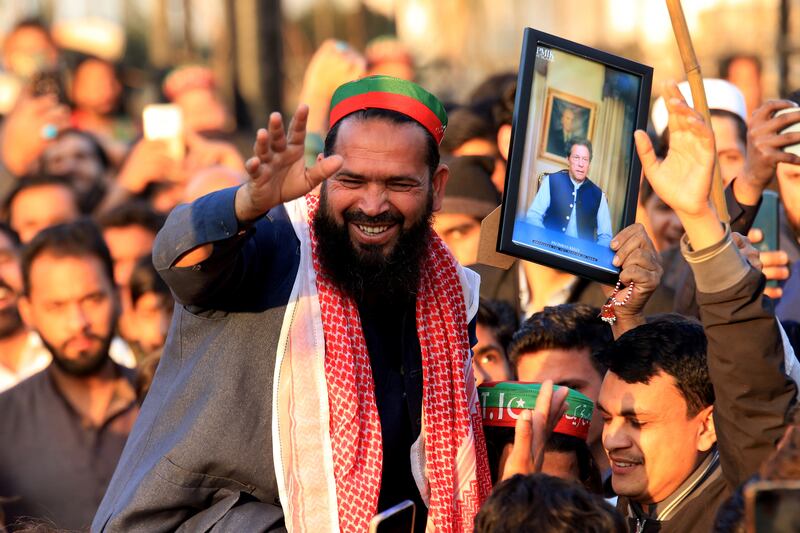 A man holds a picture of convicted former Pakistani prime minister Imran Khan in Peshawar. EPA