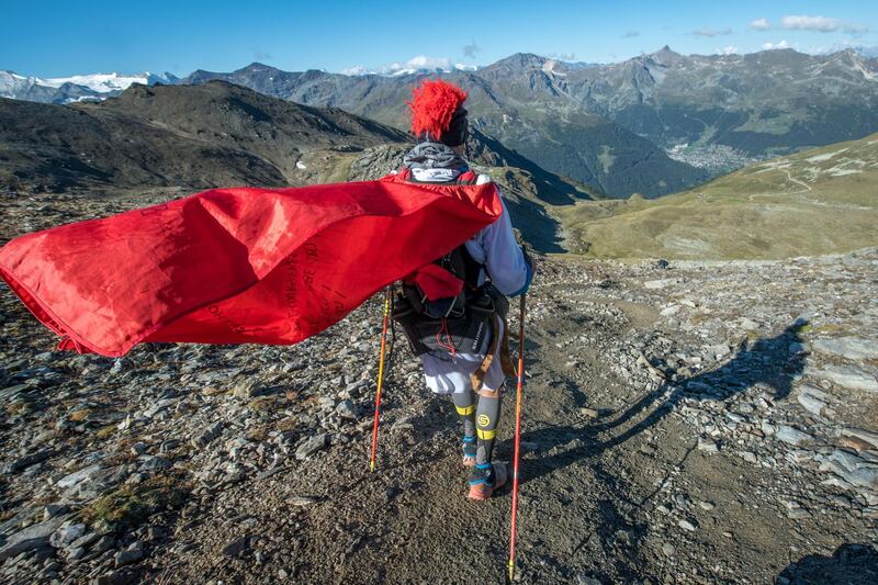 A participant of the SwissPeaks Trail surveys the scenery near Oberems, Switzerland. Maxime Schmid/EPA