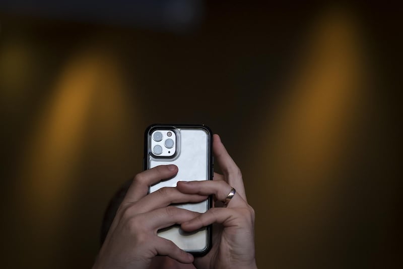 An attendee uses an iPhone 11 Pro smartphone to take a photograph during TechCrunch Disrupt 2019 in San Francisco, California, U.S., on Wednesday, Oct. 2, 2019. TechCrunch Disrupt, the world's leading authority in debuting revolutionary startups, gathers the brightest entrepreneurs, investors, hackers, and tech fans for on-stage interviews. Photographer: David Paul Morris/Bloomberg