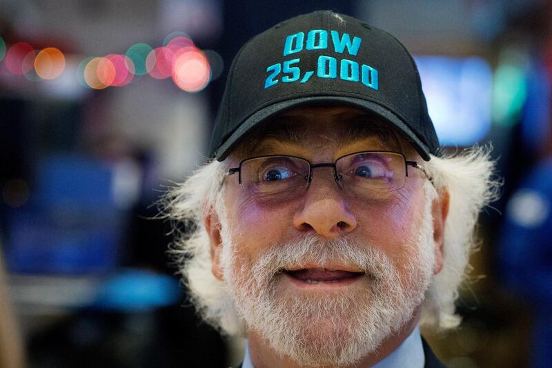 Stock trader Peter Tuchman wears a Dow 25,000 hat at the New York Stock Exchange. Mark Lennihan / AP Photo