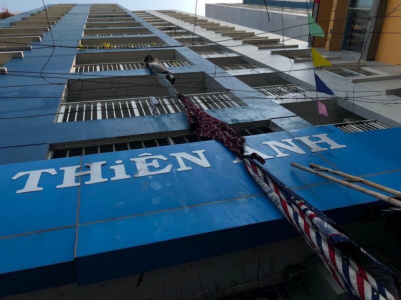 Improvised escape materials hang from a balcony at an apartment building after a fire broke out in Vietnam's southern commercial hub of Ho Chi Minh City early on March 23, 2018.



Thirteen people were killed and several injured when the fire broke out in the Carina Plaza highrise building, which started around midnight on the lower floors of the building and soon spread to the upper floors. / AFP PHOTO / STR