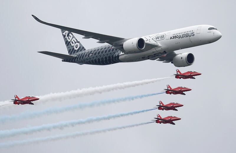 FILE PHOTO: An Airbus A350 aircraft flies in formation with Britain's Red Arrows flying display team at the Farnborough International Airshow in Farnborough, Britain July 15, 2016.  REUTERS/Peter Nicholls/File Photo