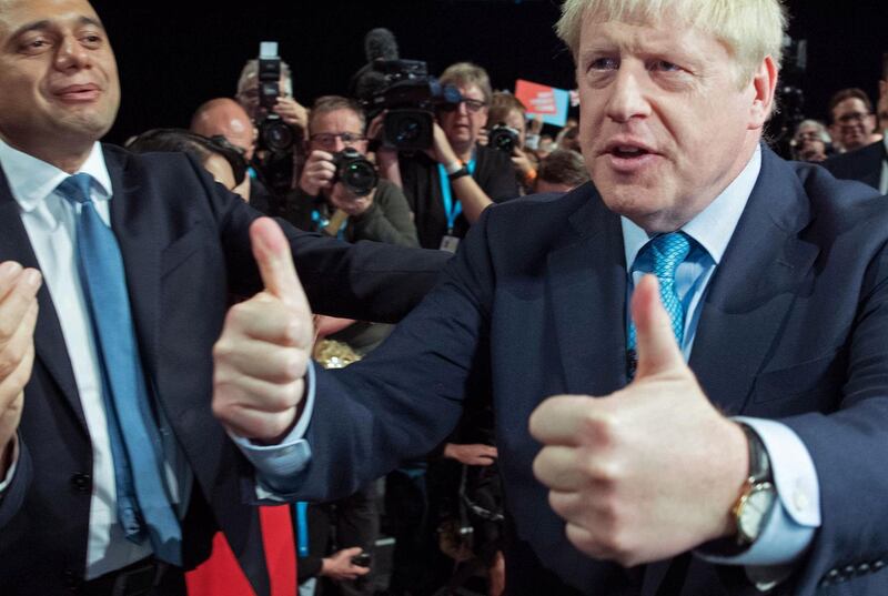 TOPSHOT - Britain's Prime Minister Boris Johnson (R) acknowledges the applause from Britain's Chancellor of the Exchequer Sajid Javid (L) and members of his cabinet as he leaves after delivering his keynote speech to delegates on the final day of the annual Conservative Party conference at the Manchester Central convention complex, in Manchester, north-west England on October 2, 2019. Prime Minister Boris Johnson was set to unveil his plan for a new Brexit deal at his Conservative party conference Wednesday, warning the EU it is that or Britain leaves with no agreement this month. Downing Street said Johnson would give details of a "fair and reasonable compromise" in his closing address to the gathering in Manchester, and would table the plans in Brussels the same day. / AFP / POOL / Stefan Rousseau
