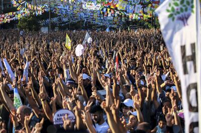 Supporters of imprisoned Selahattin Demirtas, presidential candidate of the pro-Kurdish People's Democratic Party (HDP), react during an election campaign rally in Diyarbakir on June 20, 2018. - The Turkish President announced on April 18, 2018 that Turkey will hold snap elections on June 24, 2018. (Photo by - / AFP)