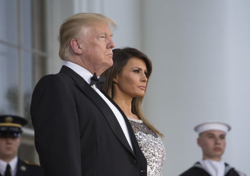 U.S. President Donald Trump, center left, and U.S. First Lady Melania Trump, center right, arrive to greet Emmanuel Macron, France's president, and Brigitte Macron, France's first lady, not pictured, on the North Portico ahead of a State Dinner at the White House in Washington, D.C., U.S., on Tuesday, April 24, 2018. Macron arrived in Washington on Monday for a three-day visit heavy on symbolism and substance as Donald Trump hosts the first official state visit of his presidency. Photographer: Chris Kleponis/Pool via Bloomberg