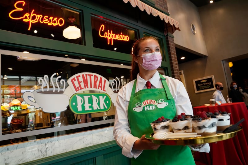 Madison Lakratz offers chocolate trifles to visitors to the "Friends"-inspired "Central Perk Cafe" at the Warner Bros.  Studio Tour Hollywood media preview on June 24, 2021, in Burbank, Calif.  (AP Photo / Chris Pizzello)