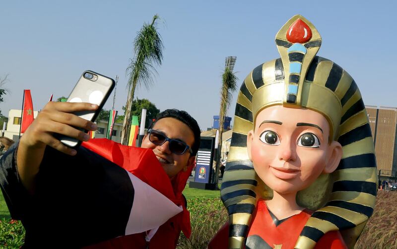 A supporter poses with the official Mascot Tut before the opening match of the 2019 Africa Cup of Nations between Egypt and Zimbabwe at Cairo International Stadium in Cairo, Egypt. EPA