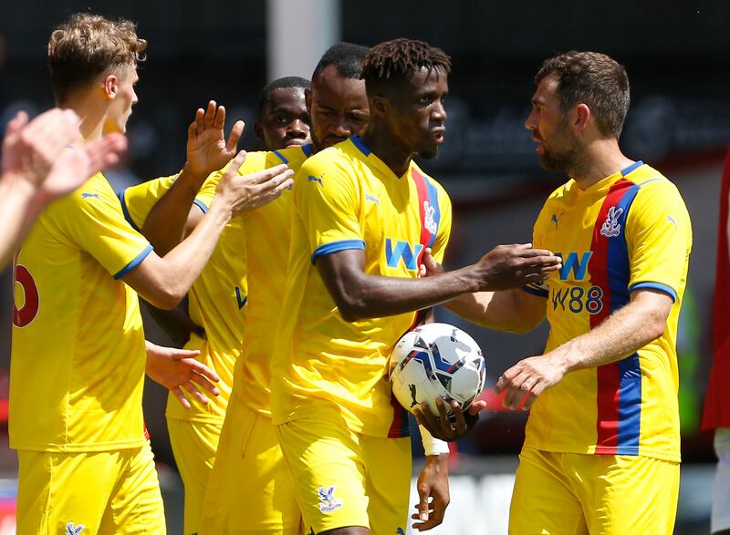 Palace's Wilfried Zaha celebrates with teammates after scoring the only goal of the game against Walsall.