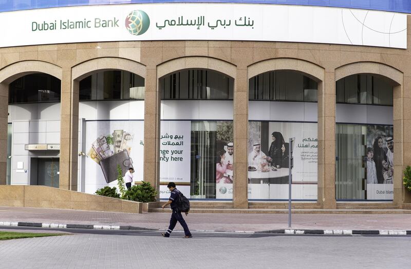Pedestrians pass a Dubai Islamic Bank PJSC bank branch in Dubai, United Arab Emirates, on Tuesday, Sept. 4, 2018. Abu Dhabi is engineering a second bank merger in its latest attempt to stay competitive in the era of lower oil prices. Photographer: Christopher Pike/Bloomberg