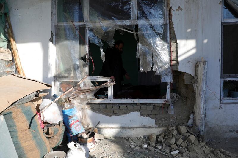 An Afghan man inspects a damaged house after a mortar shell attack in the capital, Kabul, early on December 12, 2020. At least one person was injured in the attack and another wounded, officials said. AP Photo