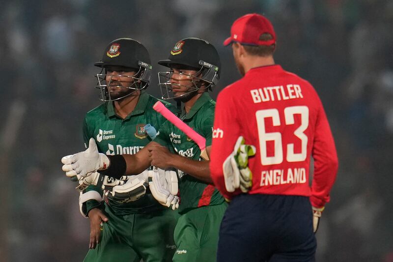 England's captain Jos Buttler, right, walks to greet Bangladesh's captain Shakib Al Hasan, left, and Afif Hossain after the first T20 in Chattogram on  March 9, 2023. AP