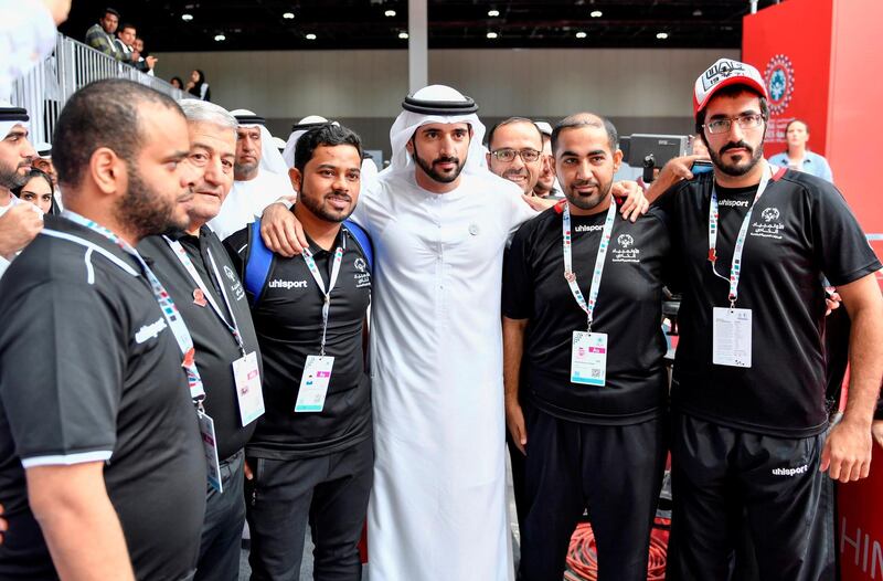 Sheikh Hamdan has his photo taken with Special Olympics volunteers during a visit to the Games at Adnec on Monday. Wam