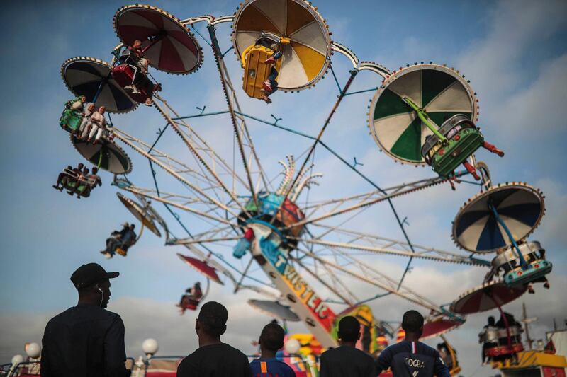 People take a ride at a summer fun fair on the last day of school holiday in Rabat, Morocco.  AP